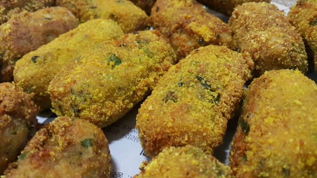 Closeup perspective view of home made spicy and delicious croquettes served with tea or other dishes during parties as fast food.