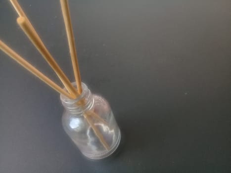 Close-Up Of Incense Sticks In glass Container Against Gray Background. Traditional aroma sticks for fragrance refreshing air