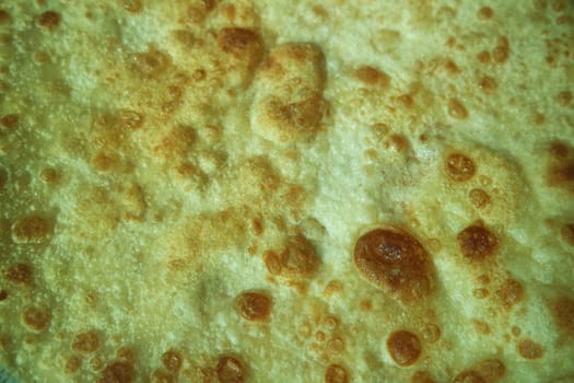 Closeup view of hand made plain bread in oil called paratha roti. Paratha is popular in India, Pakistan and other South Asian countries. Texture for bread.