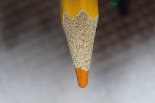 Close-up view of bright colored multicolor pencils on black background