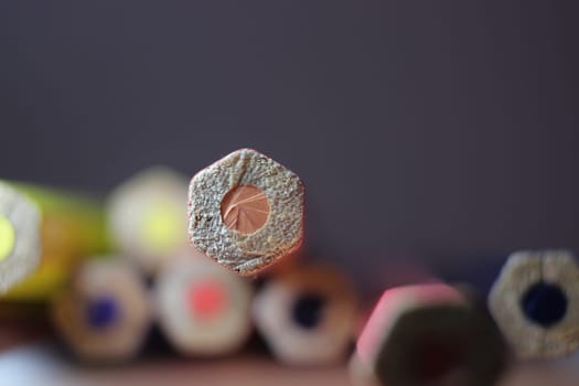 Multicolored pencils bottom macro view closeup background, education, student and school concept, wooden colorful pencil texture