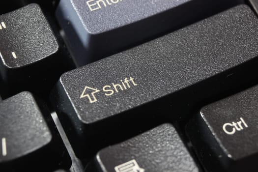 Closeup of laptop computer keyboard black keys with white letters and numbers. Black keys with white characters.