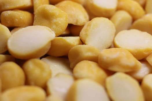 Yellow chickpea lentils seeds macro closeup view. Chana daal or yellow split peas spread background