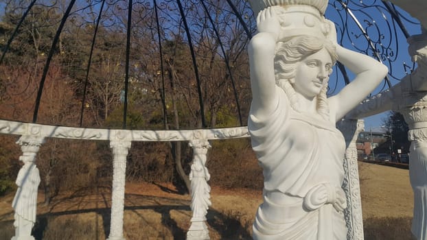 White marble statue of Greek Goddess Head with lovely hair settled in a public park