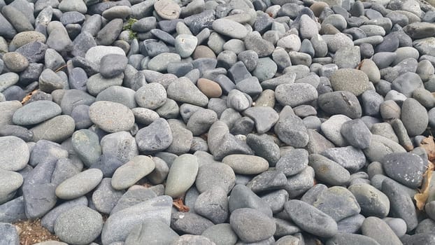 Rock Pebbles, small, rounded, smooth rocks. Texture background for text.