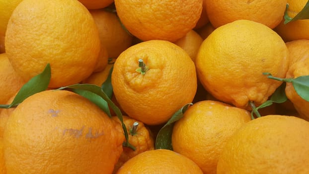 Healthy, fresh organic oranges in supermarket for sale, pile of orange in market for texture