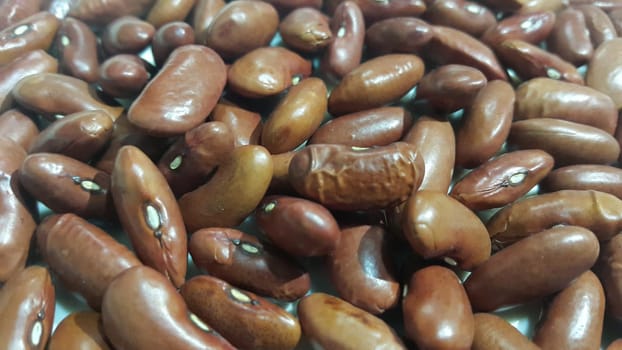 Kidenry beans:   Closeup view of uncooked red kidney beans. Dark red useful beans background.