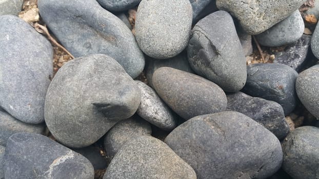 Rock Pebbles, small, rounded, smooth rocks. Texture background for text.