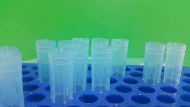Close up view of blue micro litre tips in microtip box with empty holes. Reseach lab. tool for accurate measurement.