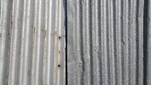 Silver corrugated metal sheet texture background. Steel metal cinc galvanized wave metal sheet for roof and walls.