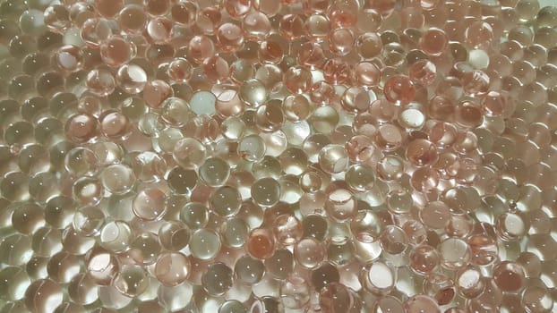 Closeup view with selective focus of shiny glittering orbeez or colorful water balls hydrogel. Water beads orbeez background.