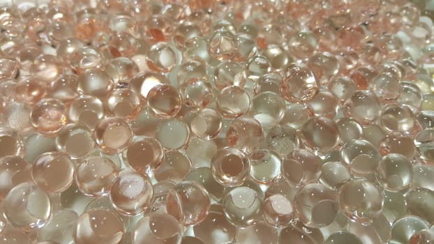 Closeup view with selective focus of shiny glittering orbeez or colorful water balls hydrogel. Water beads orbeez background.