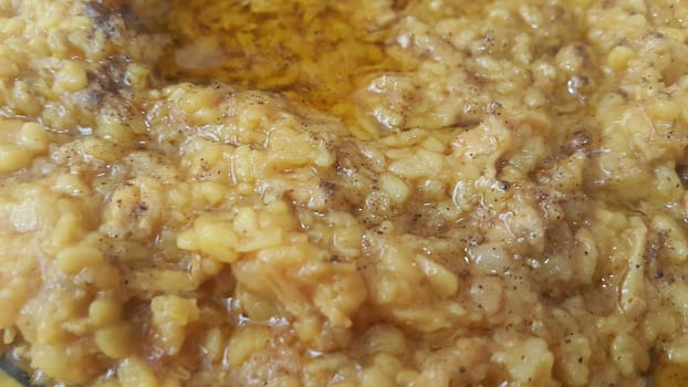 A close up view spicy daal dish served with ghee on it. Traditional Asian home made spicy lentil or daal dish..