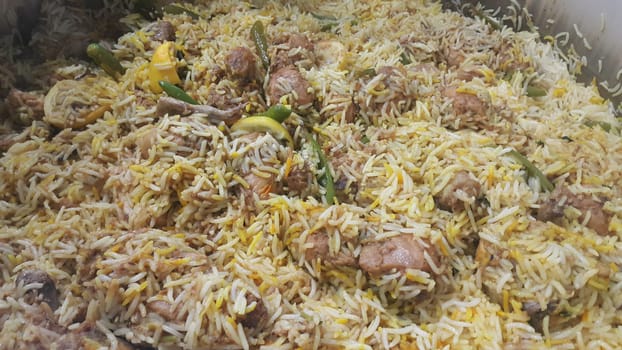 A close up  view of cooked rice chicken biryani made with traditional recipe popular for its delicious taste in Pakistan