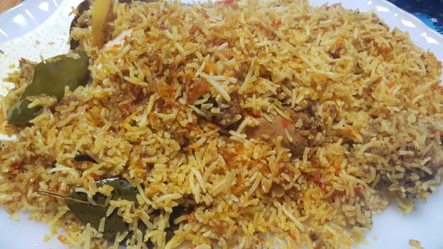 A close up  view of cooked rice chicken biryani made with traditional recipe popular for its delicious taste in Pakistan