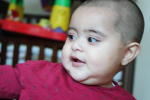 Portrait of a baby girl with smiling face, big eyes and lovely face gesture