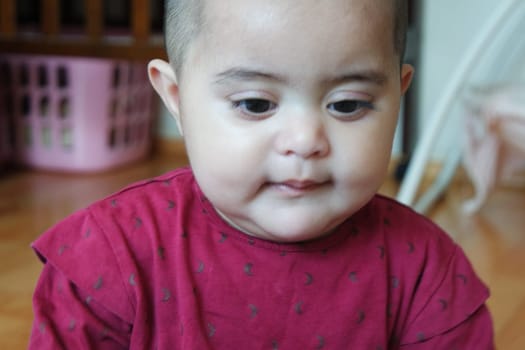 Portrait of a baby girl with smiling face, big eyes and lovely face gesture