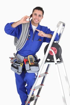Electrician surrounded by equipment