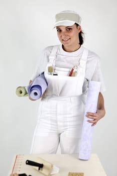 Female decorator holding wallpaper