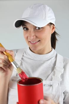 Female decorator has chosen red paint