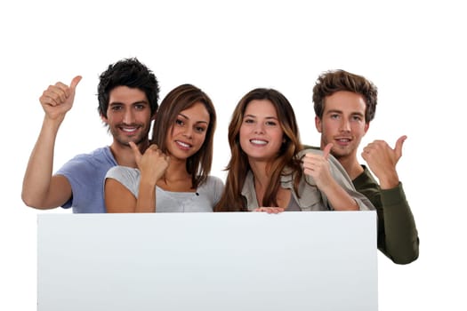 Four friends stood with blank message board