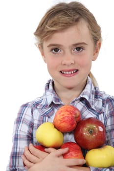 Little girl holding apples