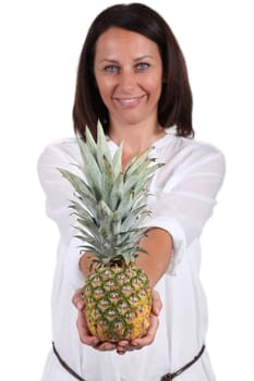 Smiling woman showing pineapple