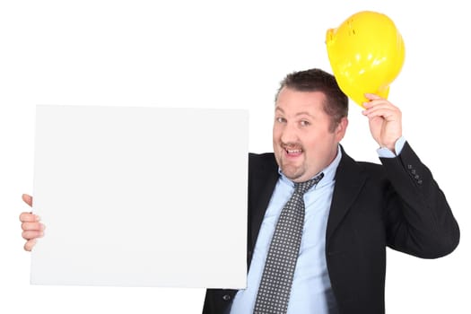 Businessman with hard hat and message board