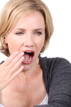 Blond woman yawning