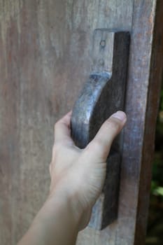 Hand on vintage wooden door, stock photo