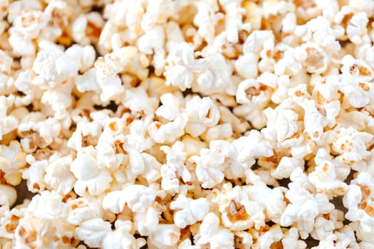full of salted popcorn on table. Selective focus. Flat lay. Concept of relax and time off. Horizontal orientation.