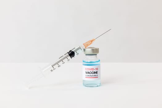 coronavirus vaccine sample with syringe on white background