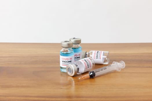 Concept of a Coronavirus covid -19 trial Multiple Vaccine Bottles with Needles