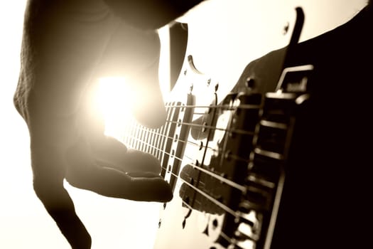 Guitarist plays on stage. Closeup view