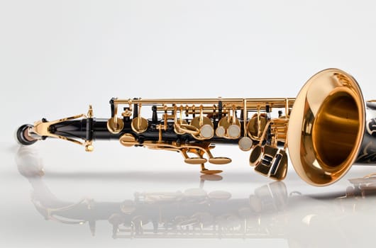 closeup of saxophone on white reflexive background