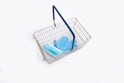 Shopping basket with hand gloves and mouth mask, isolated on white background