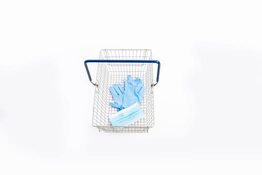 Shopping basket with hand gloves and mouth mask, isolated on white background