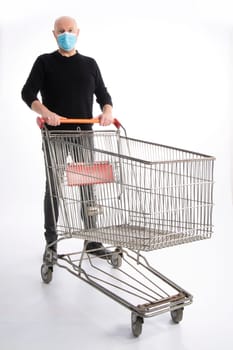 Man with mouth protection pushing a shopping cart, isolated on white background