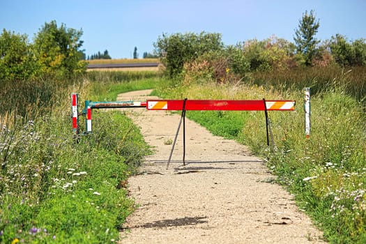 A walking path that has been closed off by barriers.