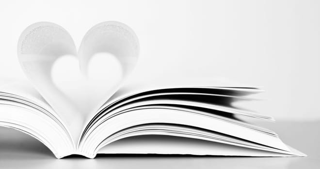Pages of a book forming the shape of the heart.
