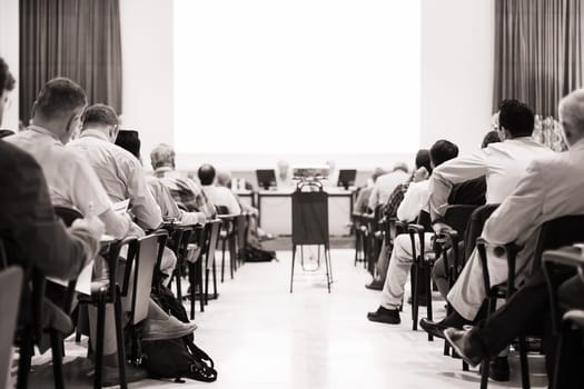 Business Conference and Presentation. Audience at the conference hall. Business and Entrepreneurship. Black and white image.