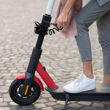 User unlocking rental electric scooter. Eco friendly green modern urban mobility concept of sharing transportation with electric scooters for rent in Ljubljana, Slovenia.