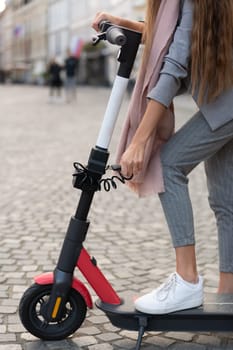 User unlocking rental electric scooter. Eco friendly green modern urban mobility concept of sharing transportation with electric scooters for rent in Ljubljana, Slovenia.