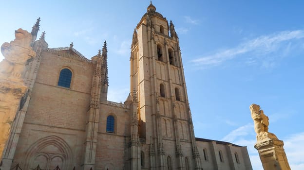 Horizontal shot of the facade of Segovia Cathedral, a sculpture in the foreground