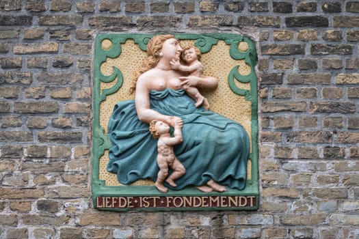 Traditional gable stone translated to Love is Fondness