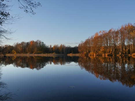blue sky yellow trees reflected in river beautiful autumn landscape