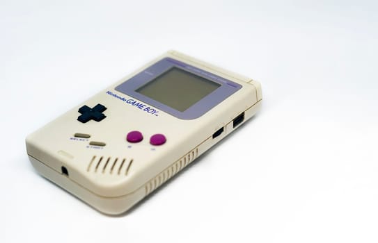 Rome, Italy, December 23, 2020: The Gameboy portable video game console from Nintendo isolated on a white background. Vintage video game console from the 90s