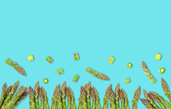 Isolated vegetable. Raw cut asparagus. top view isolated on light blue background. Panorama website header banner. High quality photo.