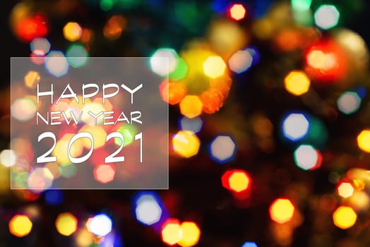 Happy New Year 2021 greeting card, blurred background of the twinkling lights of the Christmas tree. Greeting card background.