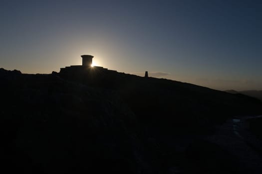 6 - Wide angle silhouette of the worcestershire beacon summit at sunrise. Part of the malvern hills, plenty of black copy space in the lower half.